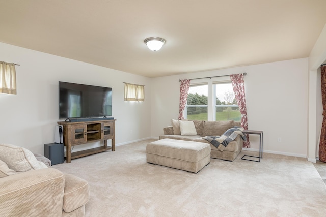 living room featuring light colored carpet and baseboards