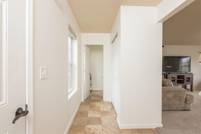 hall featuring baseboards