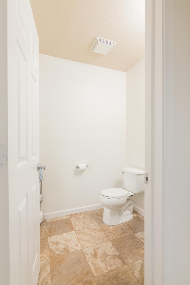 bathroom with visible vents, baseboards, and toilet