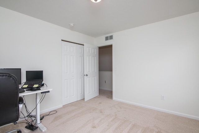 office space with baseboards, visible vents, and carpet