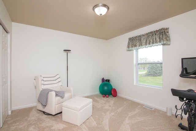 sitting room with carpet floors, baseboards, and visible vents
