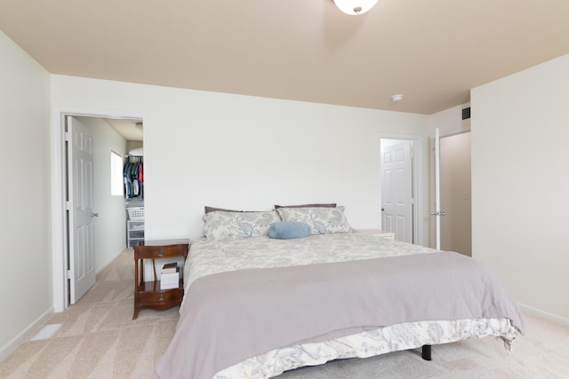 bedroom featuring baseboards and light colored carpet