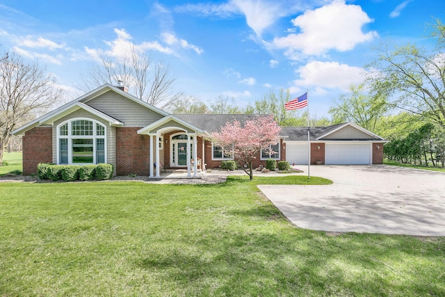single story home with brick siding, a garage, a front lawn, and concrete driveway