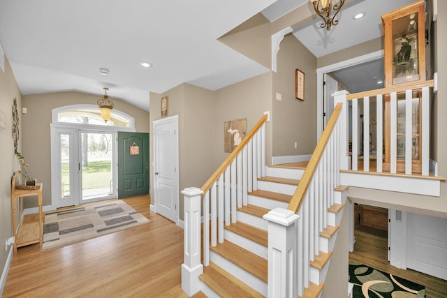 entryway with stairs, recessed lighting, baseboards, light wood-type flooring, and vaulted ceiling