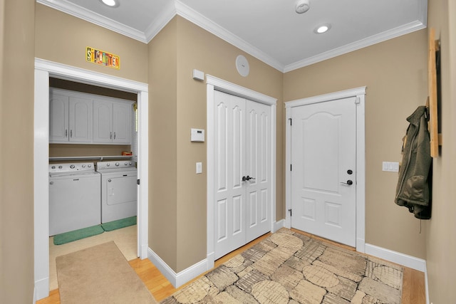 entrance foyer featuring ornamental molding, baseboards, light wood-style floors, recessed lighting, and separate washer and dryer