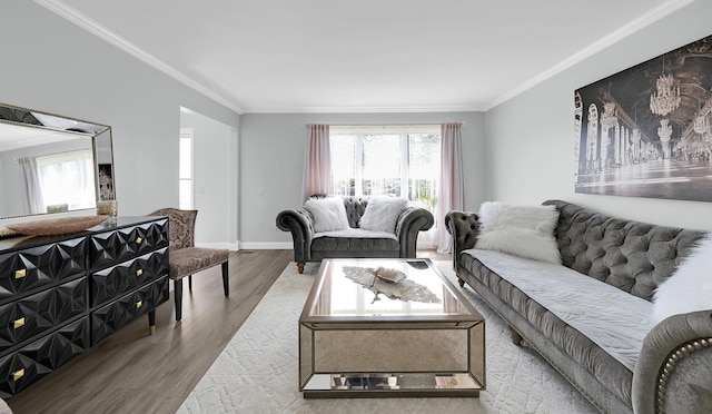 living room with baseboards, ornamental molding, and wood finished floors