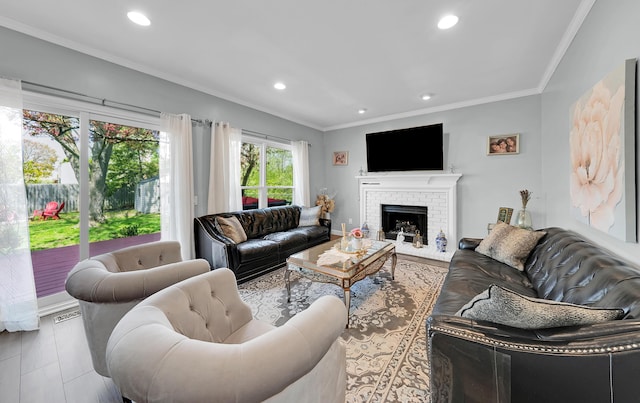 living room featuring recessed lighting, ornamental molding, a brick fireplace, and wood finished floors