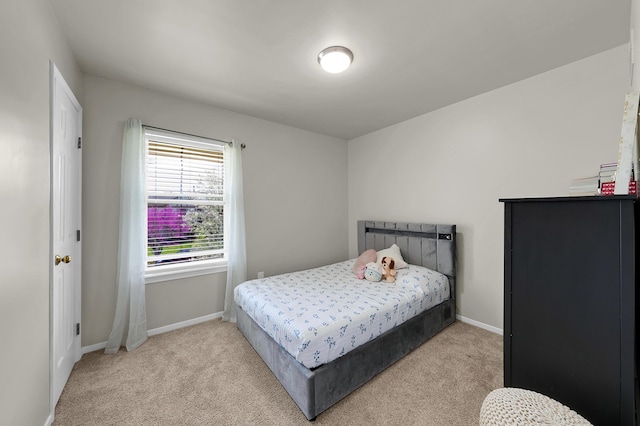 carpeted bedroom featuring baseboards