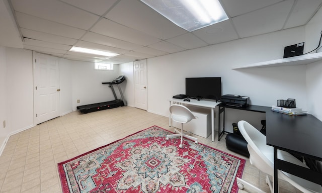 home office featuring baseboards and a drop ceiling