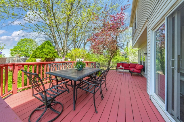 wooden deck with fence, outdoor dining space, and outdoor lounge area