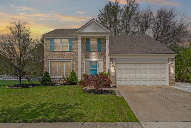 traditional-style home with an attached garage, brick siding, a chimney, concrete driveway, and a yard