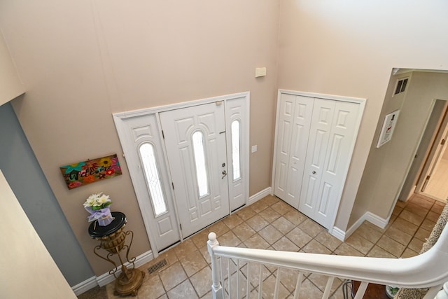 51466 Promenade Ln, New Baltimore, MI 48047 - foyer entrance featuring a towering ceiling, baseboards, and light tile patterned flooring