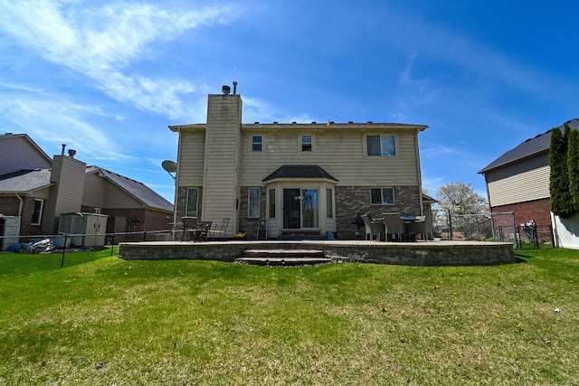51466 Promenade Ln, New Baltimore, MI 48047 - back of property with a chimney and a patio