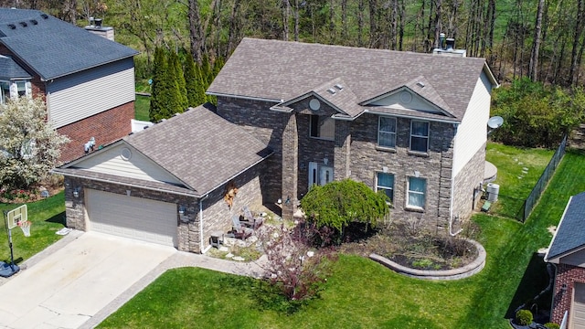 51466 Promenade Ln, New Baltimore, MI 48047 - traditional-style home with a garage, a front lawn, concrete driveway, and stone siding