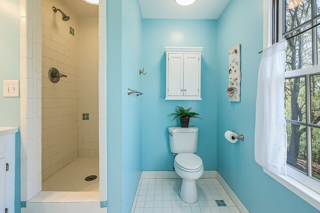 full bathroom with toilet, tile patterned floors, a shower stall, and baseboards