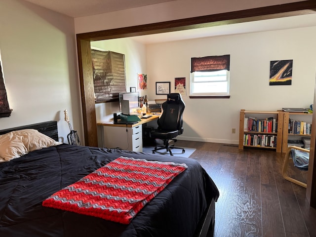 bedroom featuring baseboards and hardwood / wood-style flooring