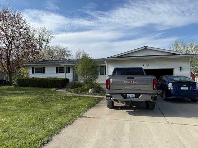 ranch-style home featuring concrete driveway, a front lawn, and a garage