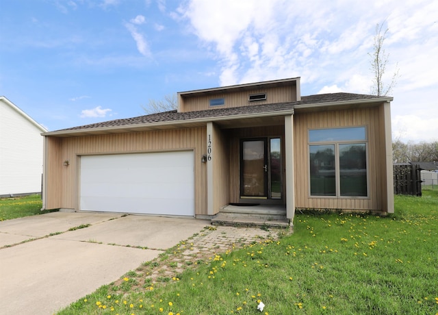 view of front of home with fence, a shingled roof, a garage, a front yard, and driveway