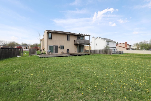 back of house with a lawn, fence, and a deck
