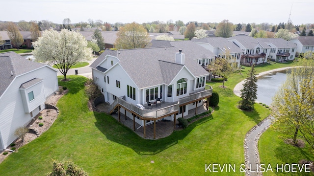 drone / aerial view featuring a water view and a residential view