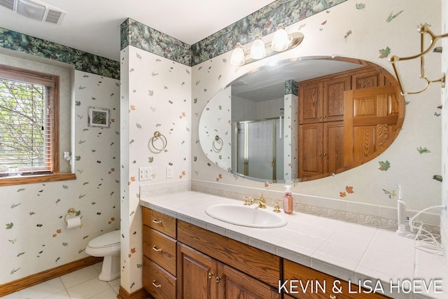 bathroom with visible vents, tile patterned flooring, a shower stall, vanity, and toilet