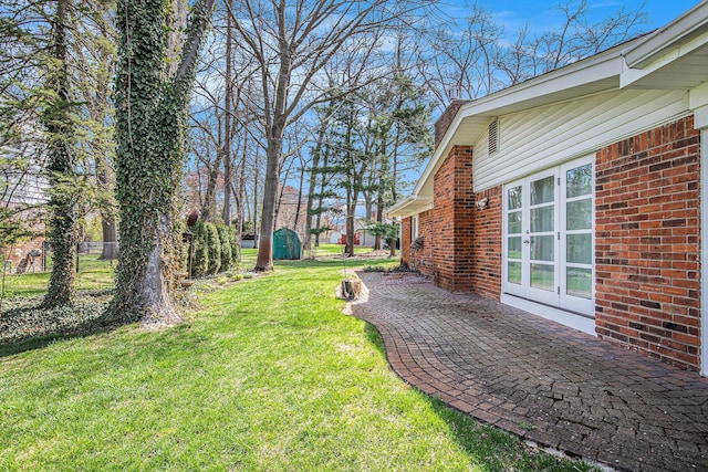 view of yard featuring a patio area and french doors