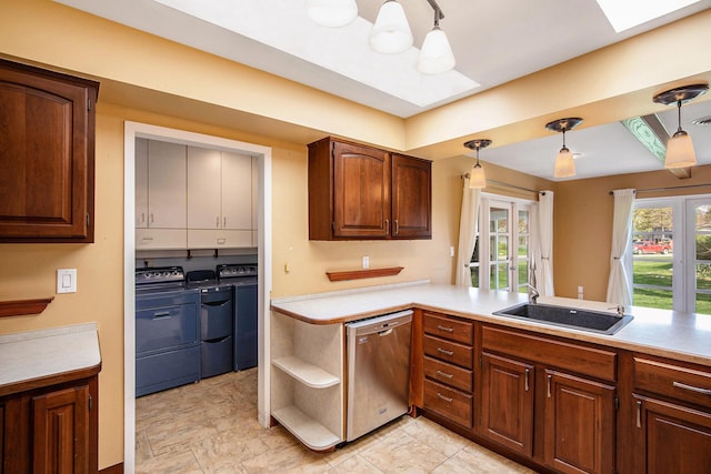 kitchen with pendant lighting, stainless steel dishwasher, open shelves, light countertops, and washer and clothes dryer