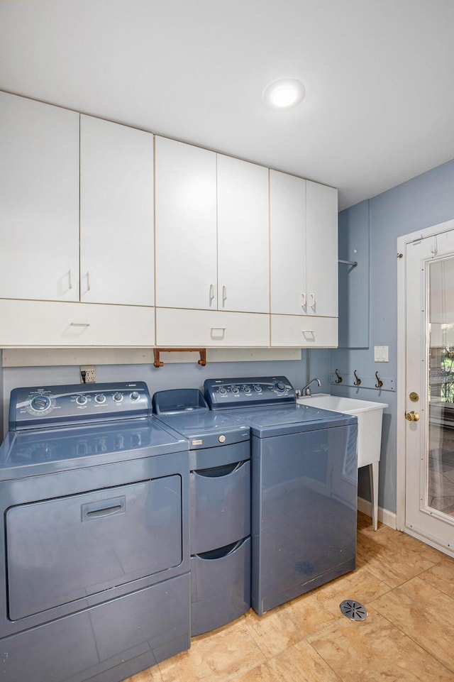 laundry room featuring baseboards, cabinet space, and washer and dryer