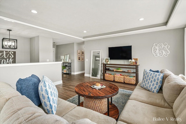 living room with recessed lighting, baseboards, an inviting chandelier, and wood finished floors