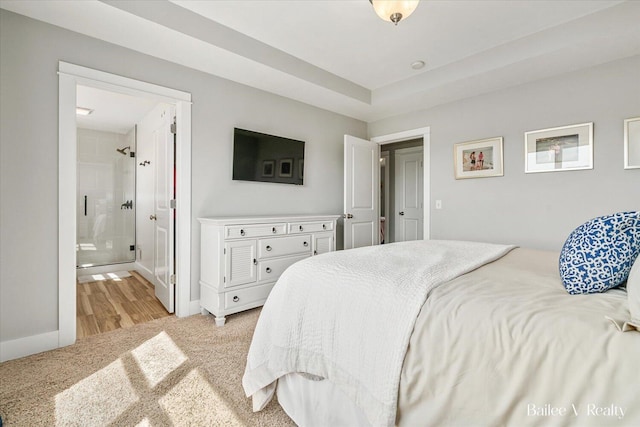 bedroom featuring baseboards and light carpet