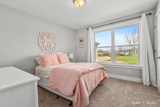 carpeted bedroom featuring baseboards and visible vents