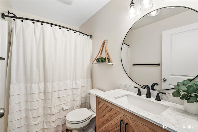 full bathroom featuring vanity and toilet
