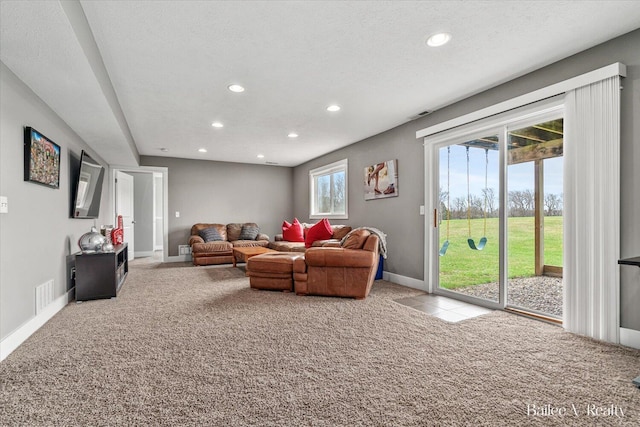 living room with baseboards, carpet flooring, recessed lighting, and visible vents