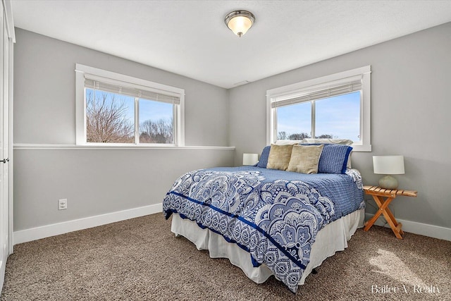 bedroom with baseboards, multiple windows, and carpet flooring