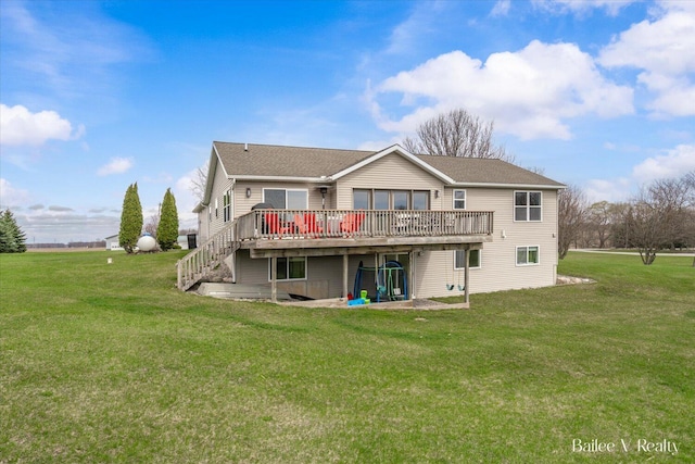rear view of property featuring roof with shingles, a yard, and a deck