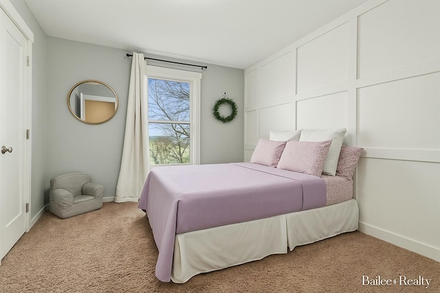 bedroom featuring baseboards and light carpet