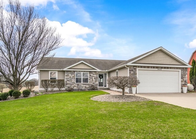 view of front of home with an attached garage, driveway, stone siding, and a front lawn