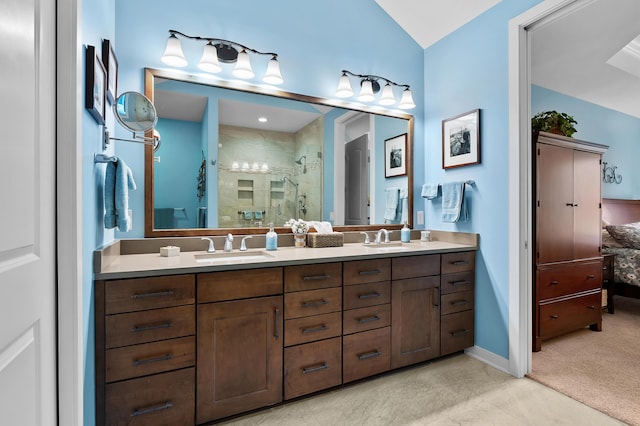 bathroom with double vanity, a sink, ensuite bathroom, and a stall shower