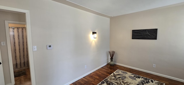 interior space with baseboards, visible vents, and dark wood-style floors