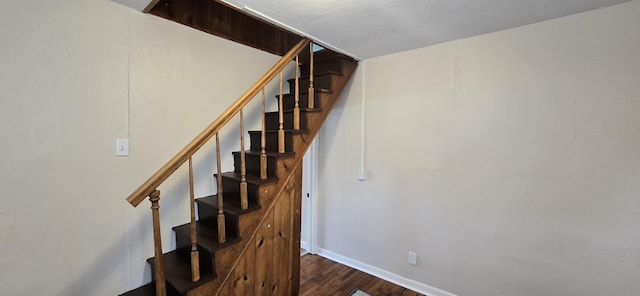 staircase with baseboards and wood finished floors