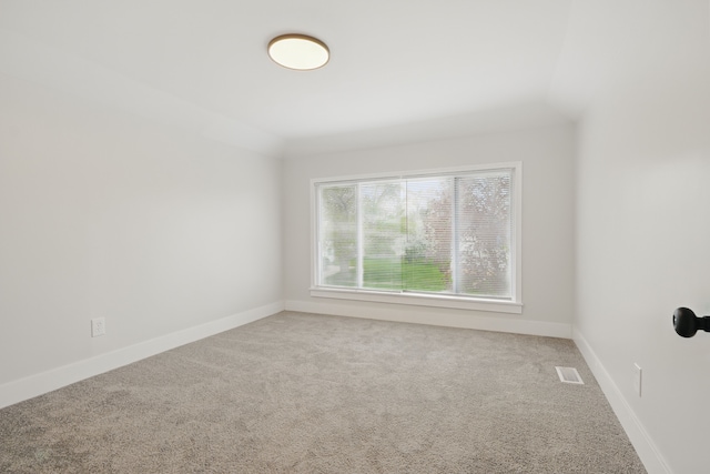 unfurnished room featuring baseboards, carpet, and visible vents
