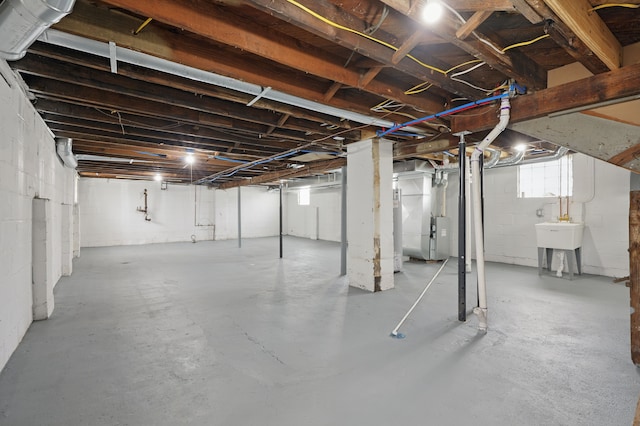 below grade area featuring a sink and heating unit