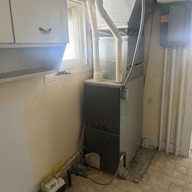 utility room featuring heating unit