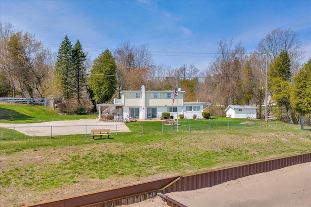 view of front of house with fence and a front yard