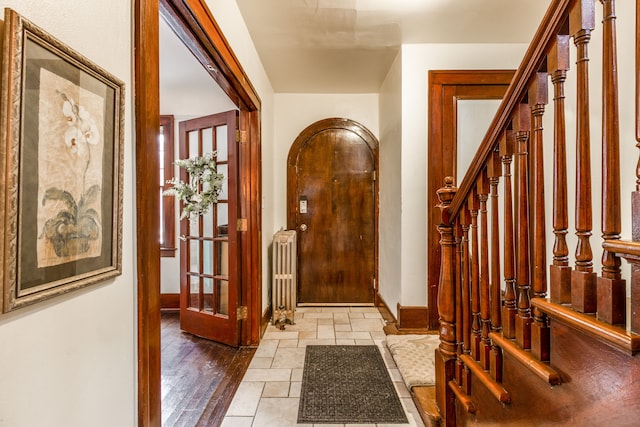 16924 Muirland St, Detroit, MI 48221 - foyer with baseboards, radiator heating unit, and stairway