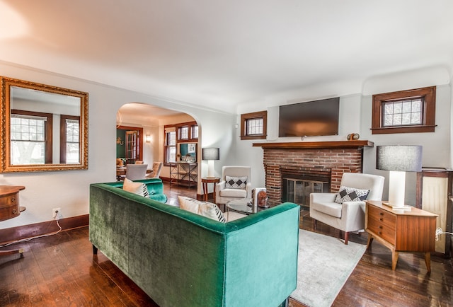 16924 Muirland St, Detroit, MI 48221 - living area with arched walkways, baseboards, a brick fireplace, and hardwood / wood-style floors