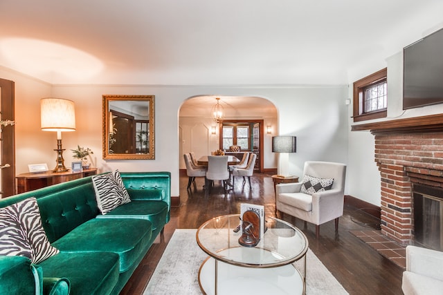 16924 Muirland St, Detroit, MI 48221 - living room featuring arched walkways, ornamental molding, wood finished floors, and a fireplace