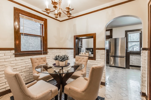 16924 Muirland St, Detroit, MI 48221 - dining area with crown molding, arched walkways, a chandelier, and wainscoting
