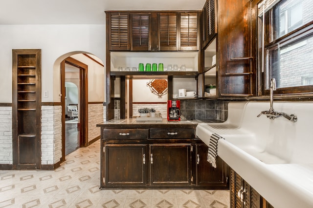 16924 Muirland St, Detroit, MI 48221 - bar with indoor wet bar, arched walkways, a sink, and a wainscoted wall