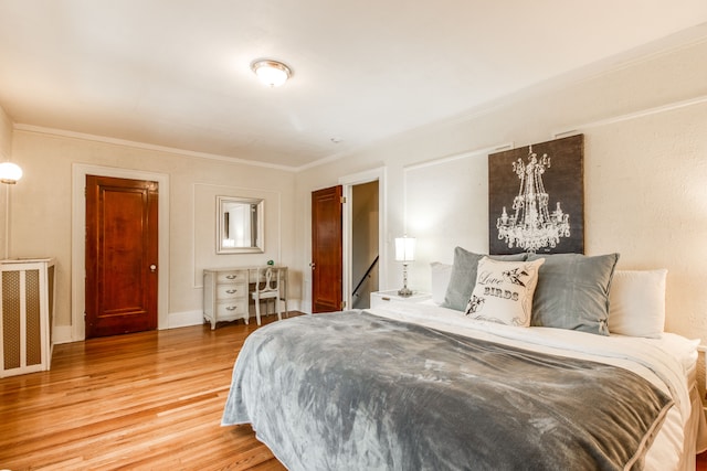 16924 Muirland St, Detroit, MI 48221 - bedroom featuring crown molding, light wood finished floors, and a chandelier